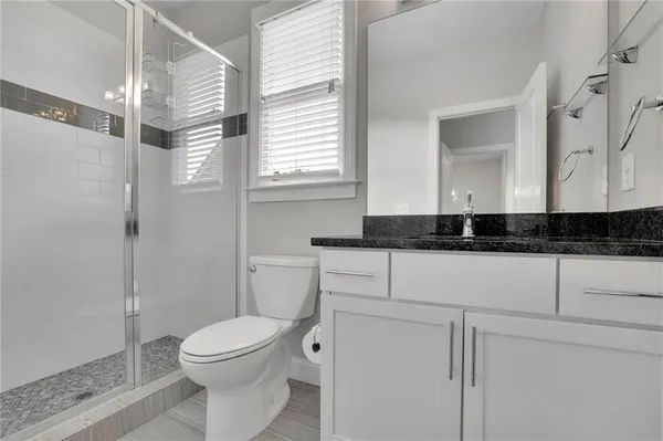 a bathroom with a toilet sink and shower