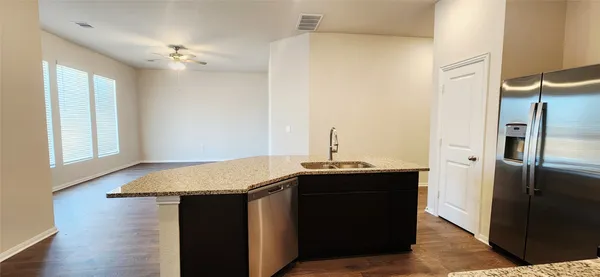 a kitchen with a sink and a refrigerator
