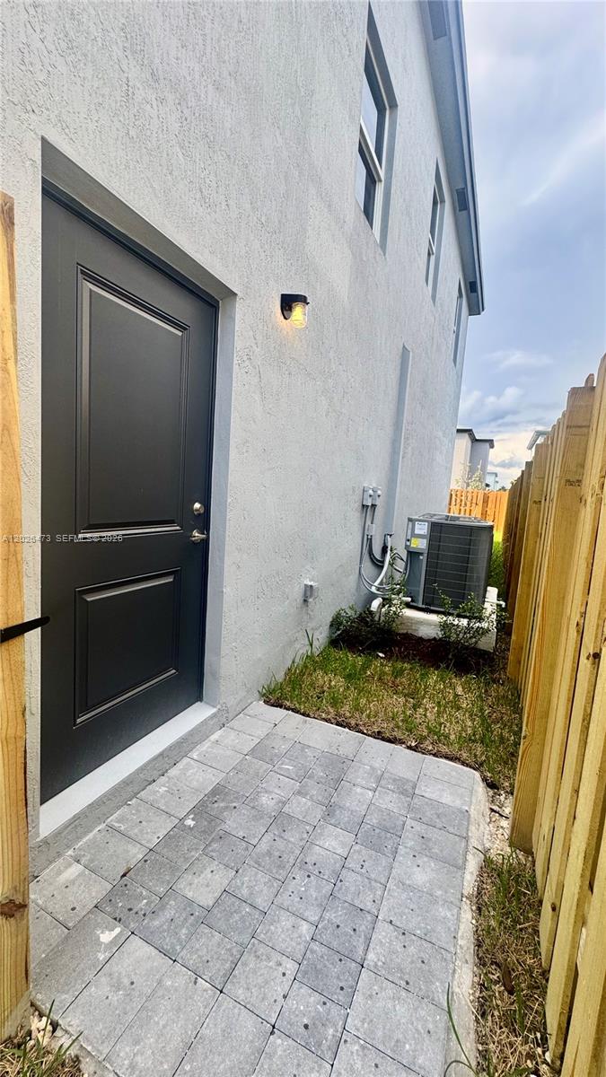 19479 Southwest 340th Street, Unit 1 Homestead, FL 33034 - Photo 45 of 58 a front view of a house with a yard