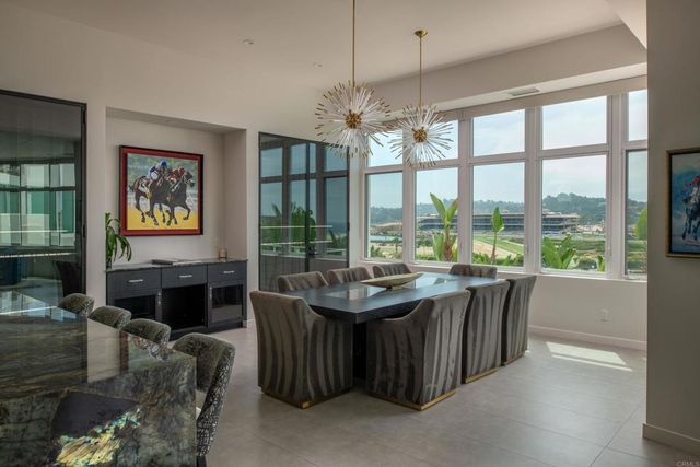 a dining room with furniture a chandelier and window