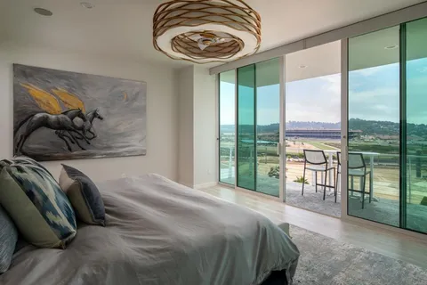 a bedroom with a bed and a painting on the wall