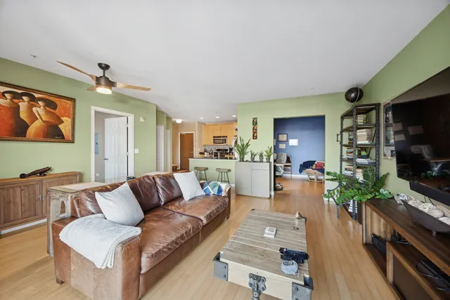 a living room with furniture flat screen tv and wooden floor