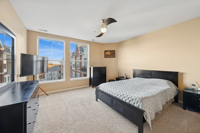 a spacious bedroom with a large bed and a large window