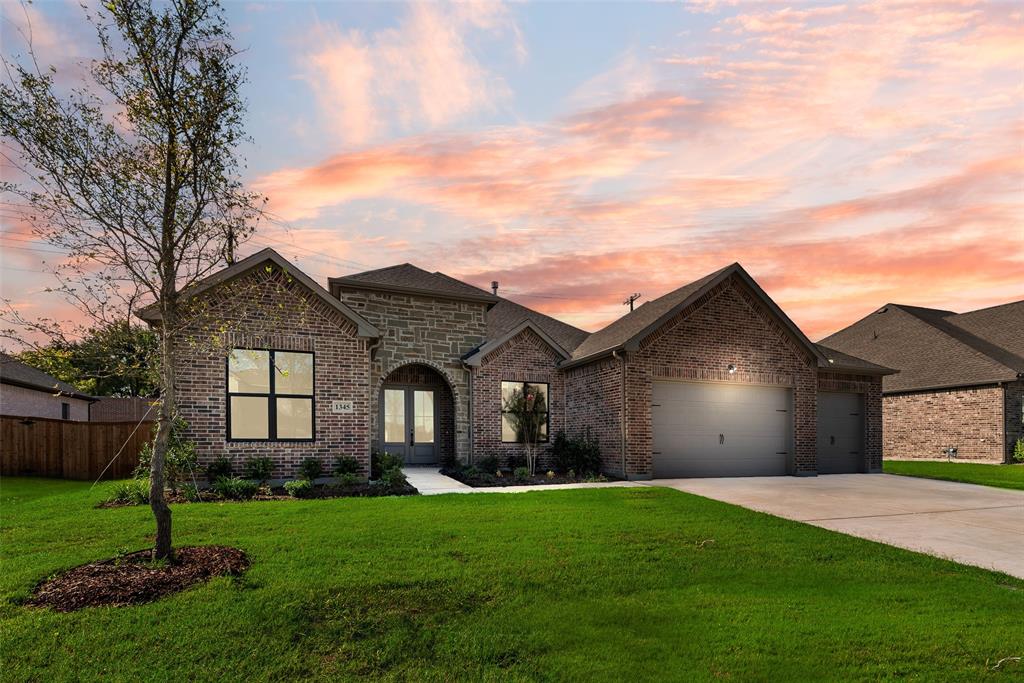 1345 Benjamin Trail Van Alstyne, TX 75495 - Photo 1 of 1 a front view of a house with a garden and yard