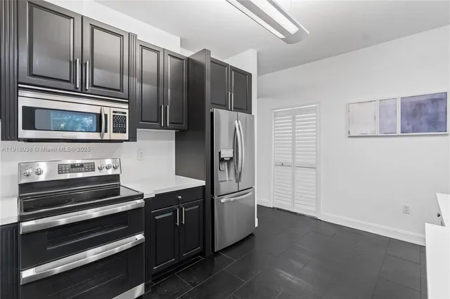 a kitchen with a sink window and cabinets