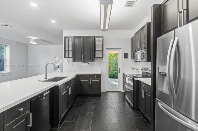 a view of a kitchen with dining area and glass windows