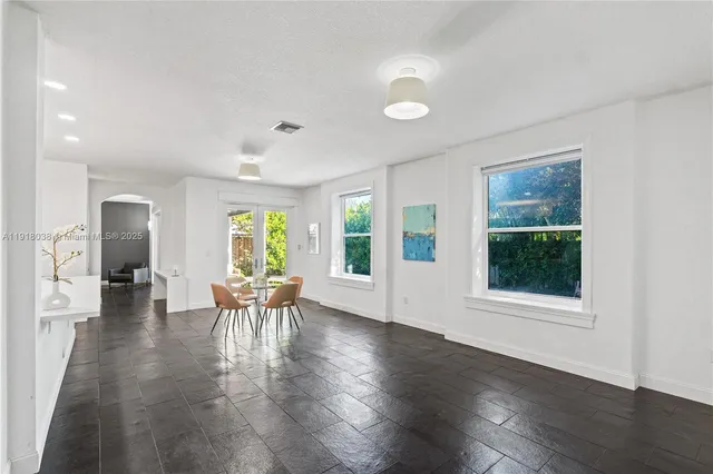 a view of a dining room with furniture and windows