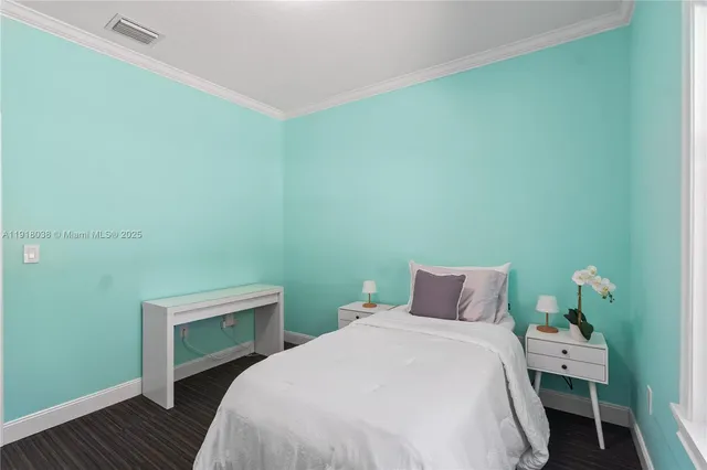 a bedroom with a bed and a view of kitchen