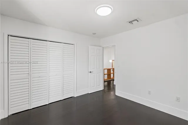 a room with walk in closet and a wooden floor