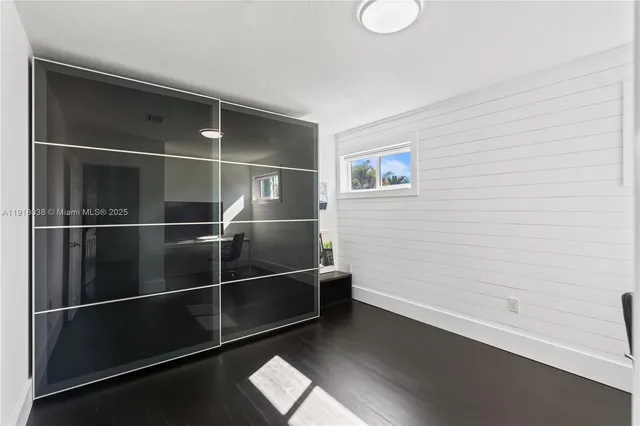 a living room with patio furniture and a floor to ceiling window