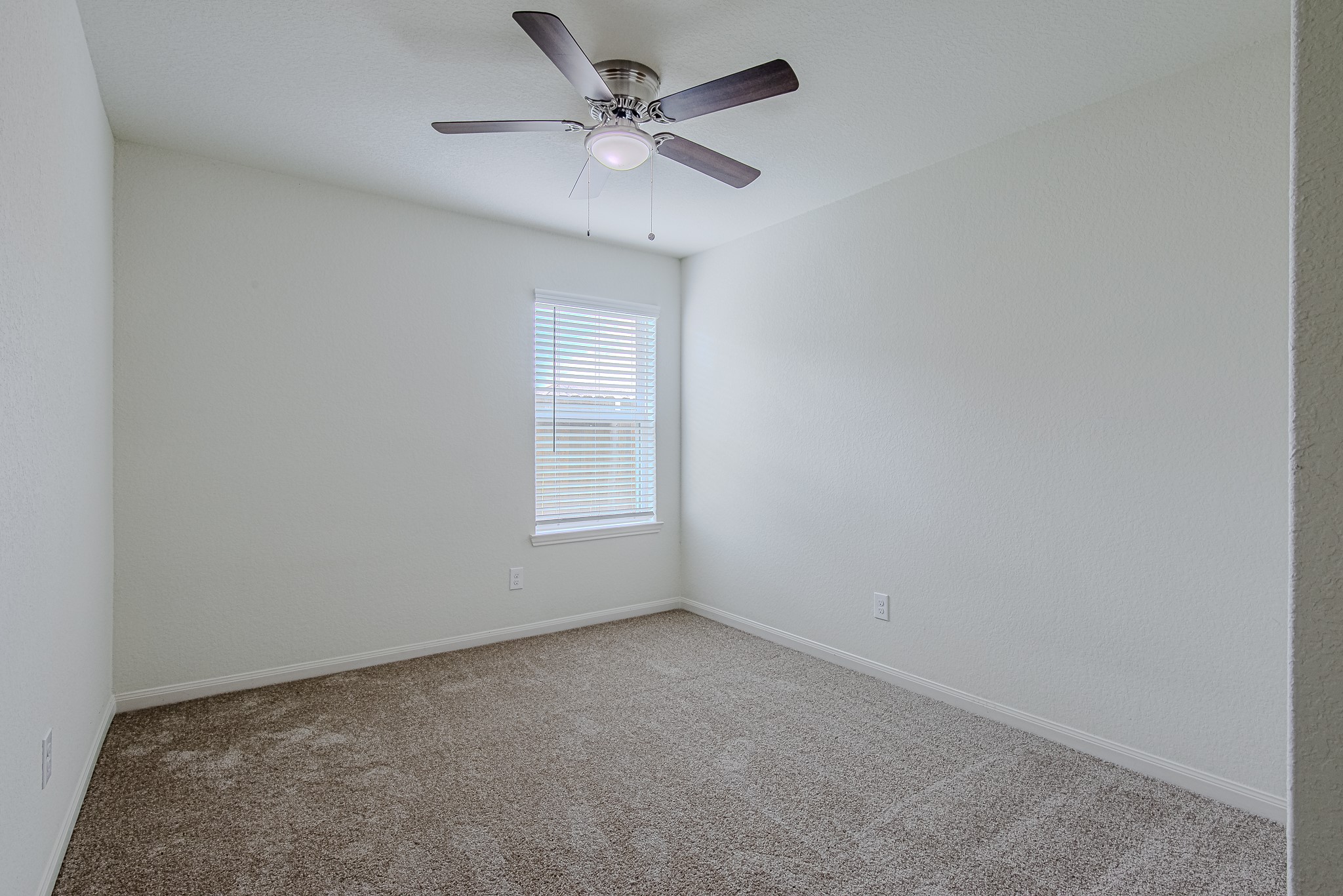 9522 Olive Stone Drive Rosharon, TX 77583 - Photo 26 of 29 an empty room with a chandelier fan and windows