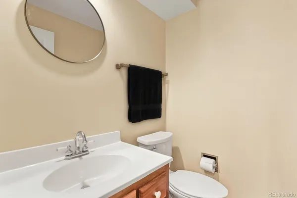 a bathroom with a sink mirror and toilet