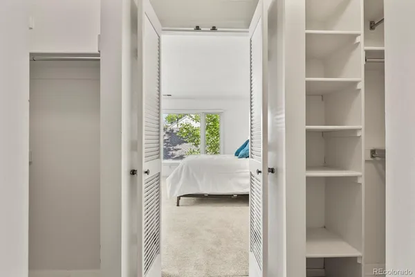 a bedroom with a bed and a window with the outer view