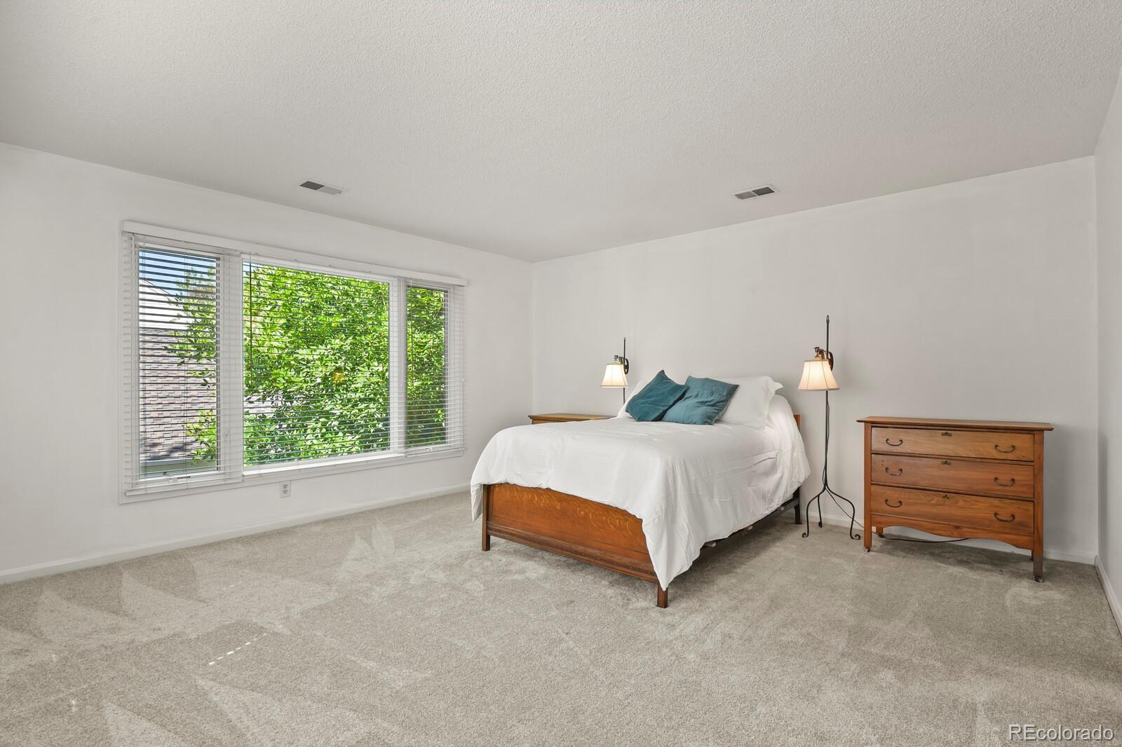 4530 South Verbena Street, Unit 309 Denver, CO 80237 - Photo 23 of 45 a spacious bedroom with a bed and a window