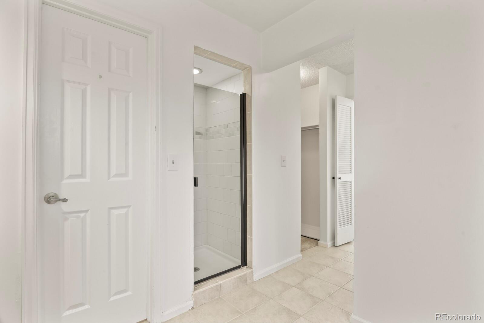 4530 South Verbena Street, Unit 309 Denver, CO 80237 - Photo 26 of 45 a view of a bathroom with shower