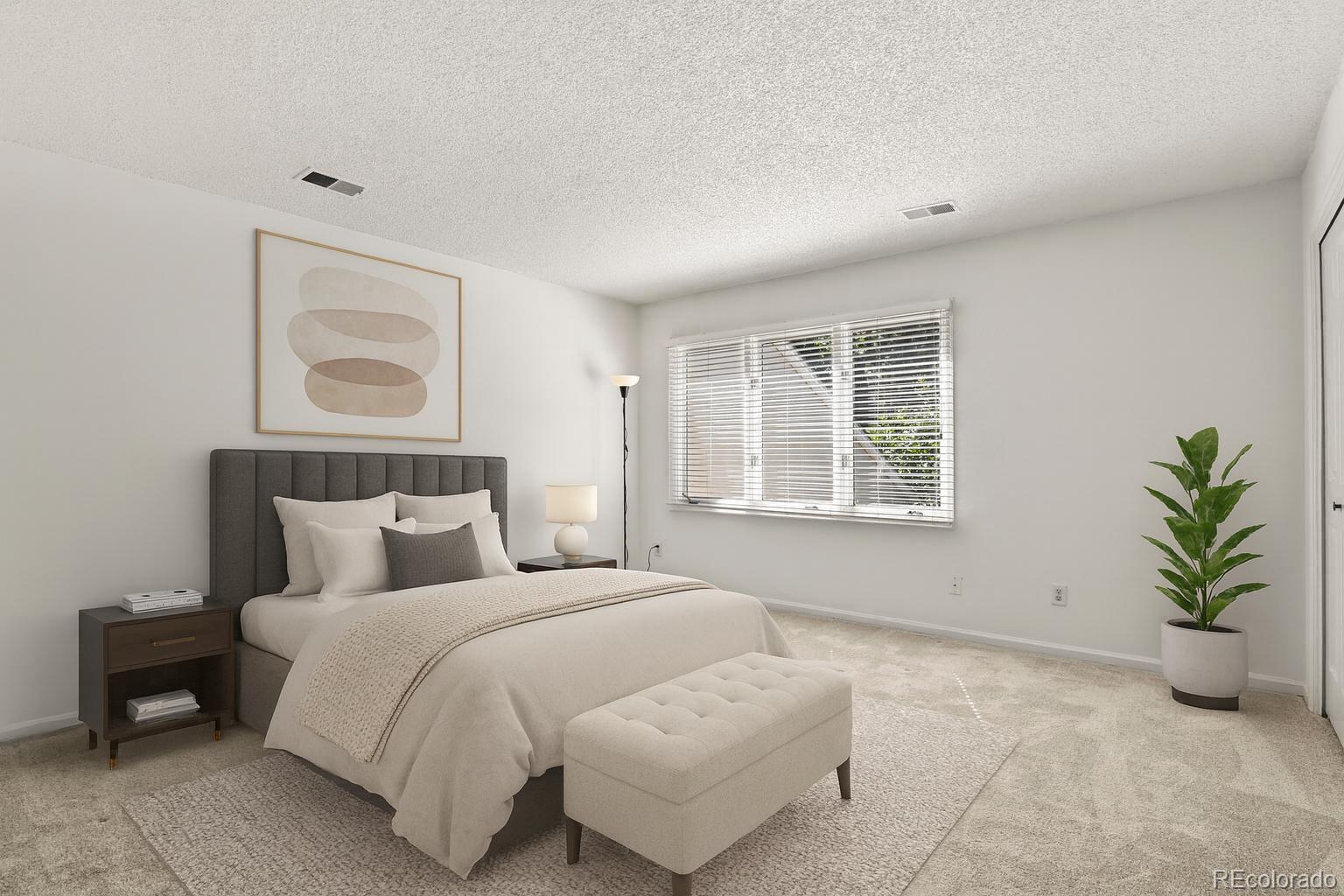 4530 South Verbena Street, Unit 309 Denver, CO 80237 - Photo 28 of 45 a bedroom with a bed and a potted plant