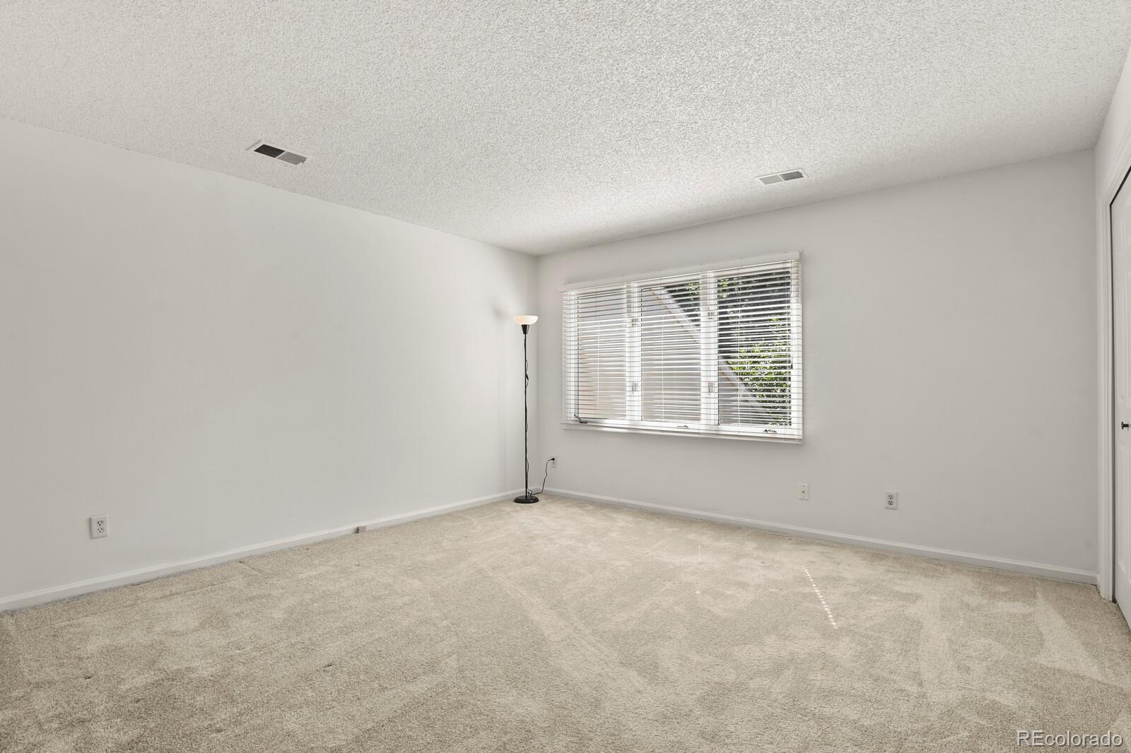 4530 South Verbena Street, Unit 309 Denver, CO 80237 - Photo 29 of 45 an empty room with windows