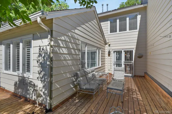 a view of deck with a table and chairs