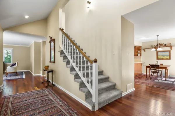 a view of entryway and hall with wooden floor