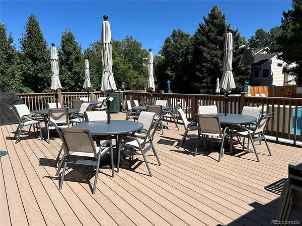 a view of a dinning tables and chairs on deck with wooden floor