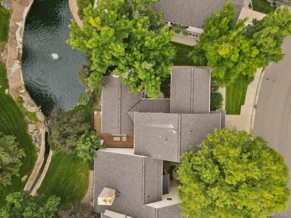 an aerial view of a house with a yard and garden