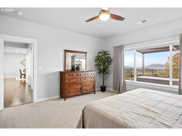 a bedroom with a bed and a large mirror