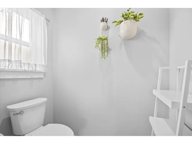 a bathroom with a sink a toilet and a window