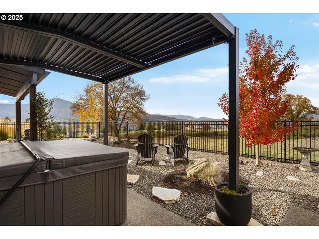 a backyard of a house with a fountain table and chairs