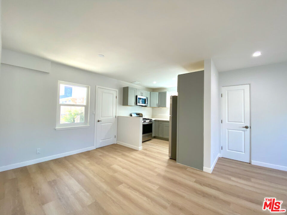 11700 Dorothy Street, Unit 2 Los Angeles, CA 90049 - Photo 12 of 31 a view of a kitchen with a sink cabinets and a window