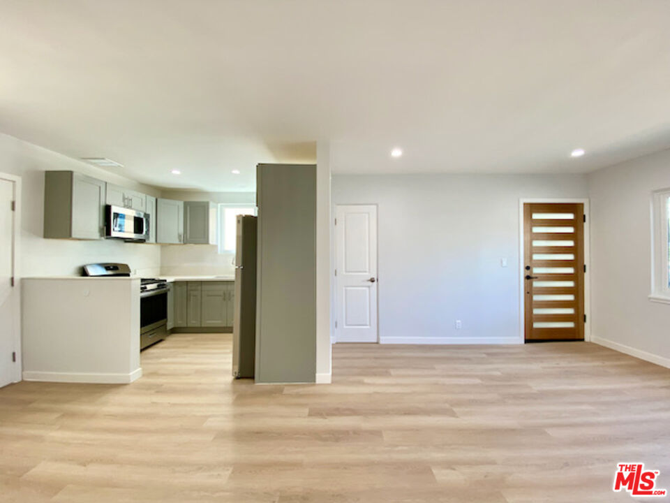 11700 Dorothy Street, Unit 2 Los Angeles, CA 90049 - Photo 13 of 31 a view of kitchen with granite countertop cabinets and refrigerator