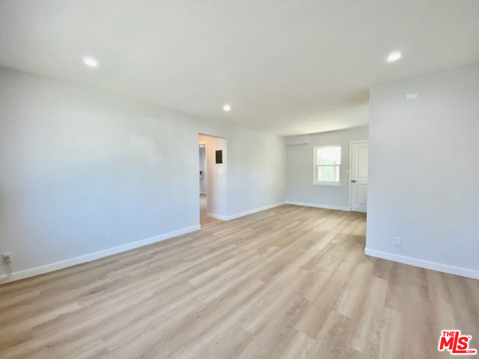 11700 Dorothy Street, Unit 2 Los Angeles, CA 90049 - Photo 14 of 31 wooden floor in an empty room with a window