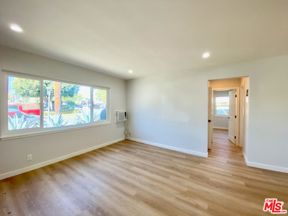 11700 Dorothy Street, Unit 2 Los Angeles, CA 90049 - Photo 15 of 31 wooden floor in an empty room with a window