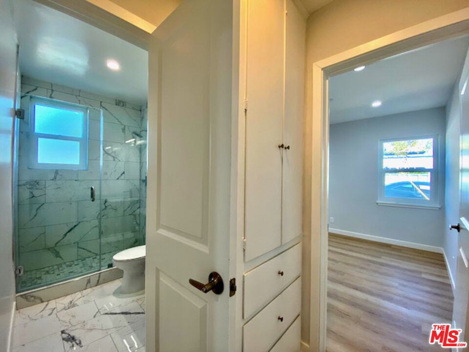 11700 Dorothy Street, Unit 2 Los Angeles, CA 90049 - Photo 16 of 31 a bathroom with a shower and a toilet