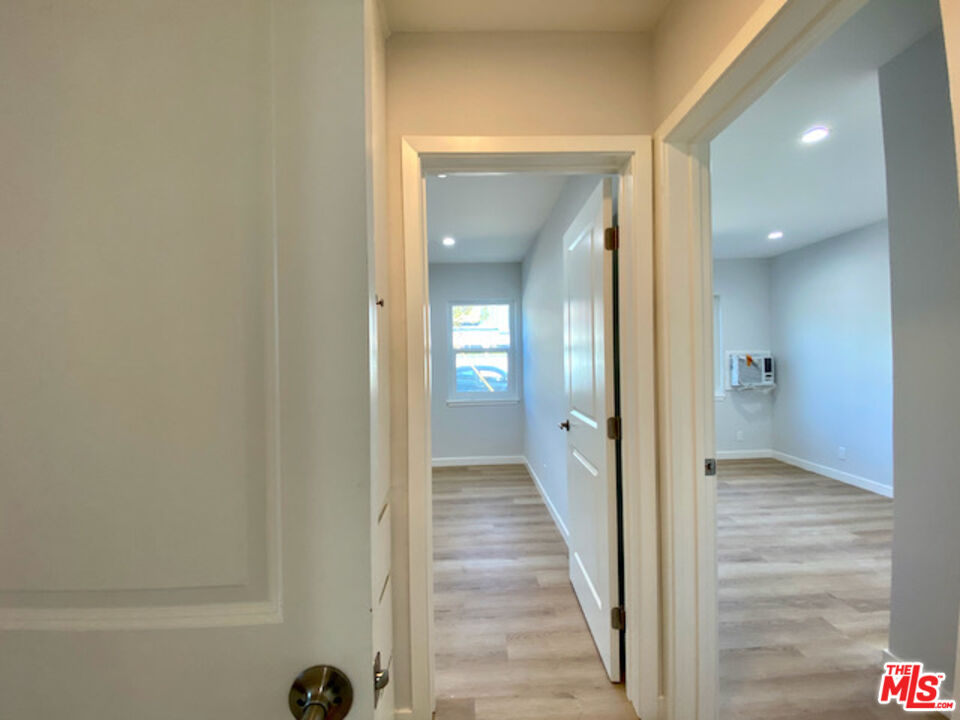 11700 Dorothy Street, Unit 2 Los Angeles, CA 90049 - Photo 17 of 31 a view of a hallway with a wooden floor