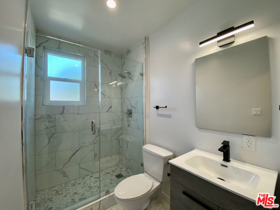 11700 Dorothy Street, Unit 2 Los Angeles, CA 90049 - Photo 18 of 31 a bathroom with a sink toilet and shower