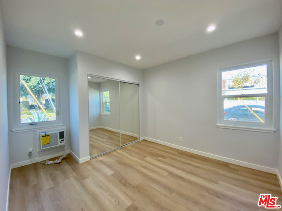 11700 Dorothy Street, Unit 2 Los Angeles, CA 90049 - Photo 19 of 31 an empty room with windows and closet