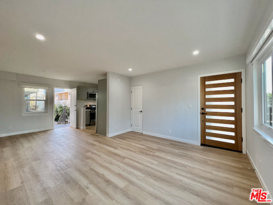 11700 Dorothy Street, Unit 2 Los Angeles, CA 90049 - Photo 25 of 31 a view of empty room with wooden floor and fan