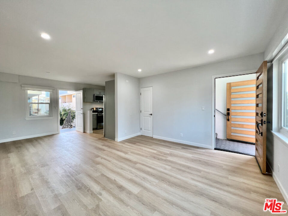 11700 Dorothy Street, Unit 2 Los Angeles, CA 90049 - Photo 27 of 31 a view of empty room with wooden floor and window