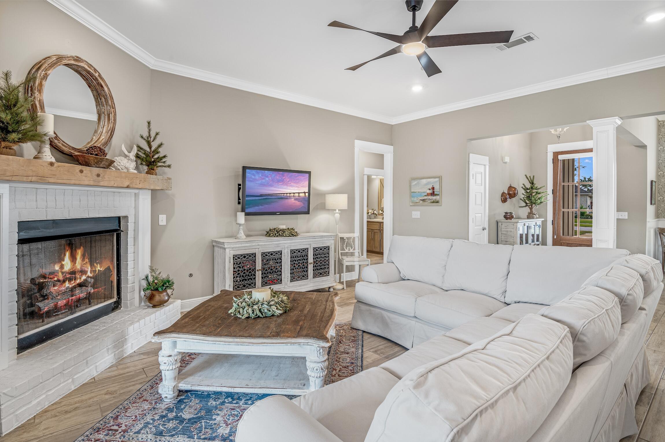 a living room with furniture a fireplace and a flat screen tv