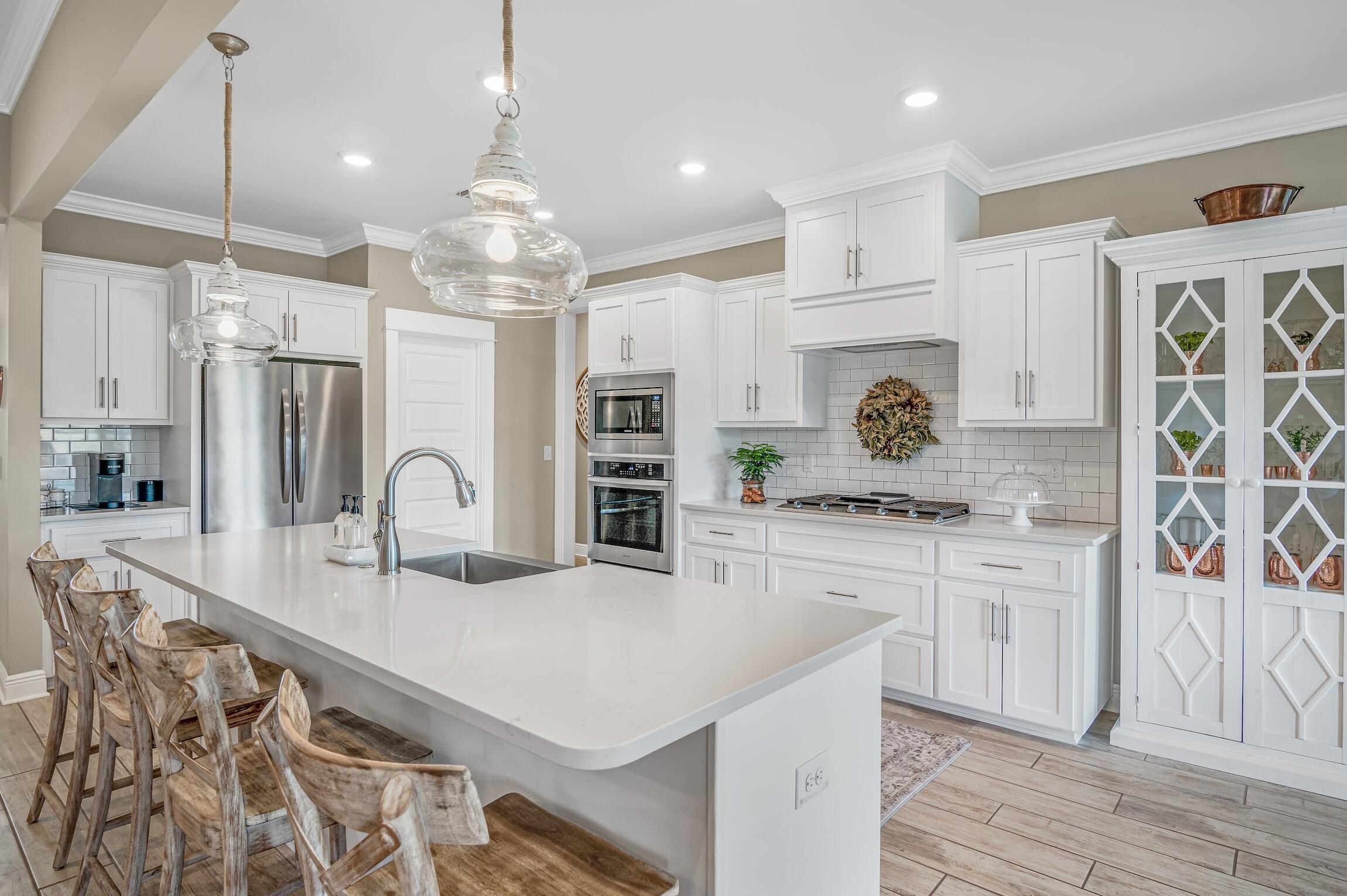 102 Mill Pond Cove Freeport, FL 32439 - Photo 11 of 46 a kitchen with stainless steel appliances granite countertop a sink stove and refrigerator