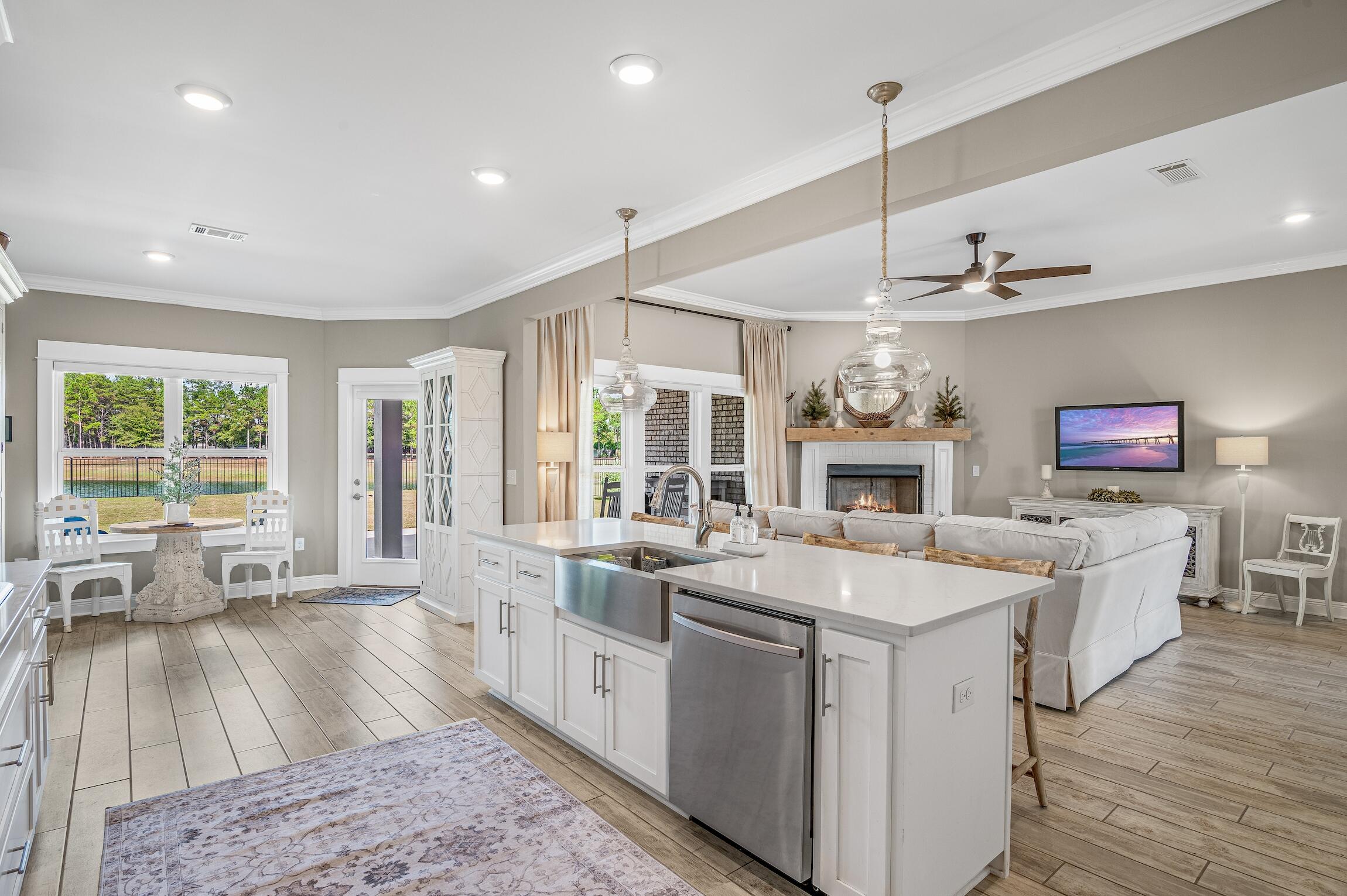 102 Mill Pond Cove Freeport, FL 32439 - Photo 13 of 46 a open kitchen with sink a counter top space a large window and stainless steel appliances