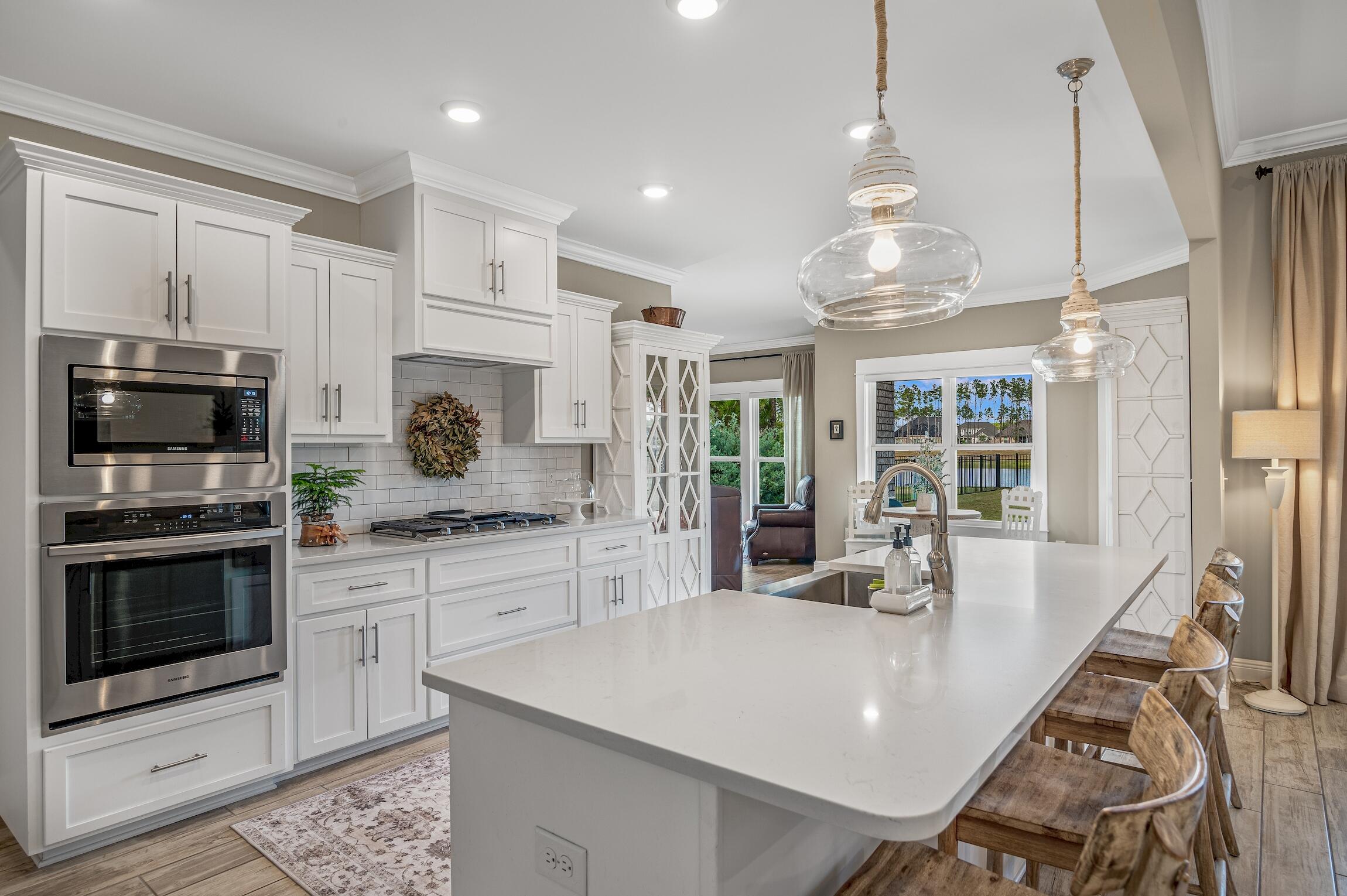 102 Mill Pond Cove Freeport, FL 32439 - Photo 14 of 46 a kitchen with stainless steel appliances granite countertop a stove refrigerator and a sink