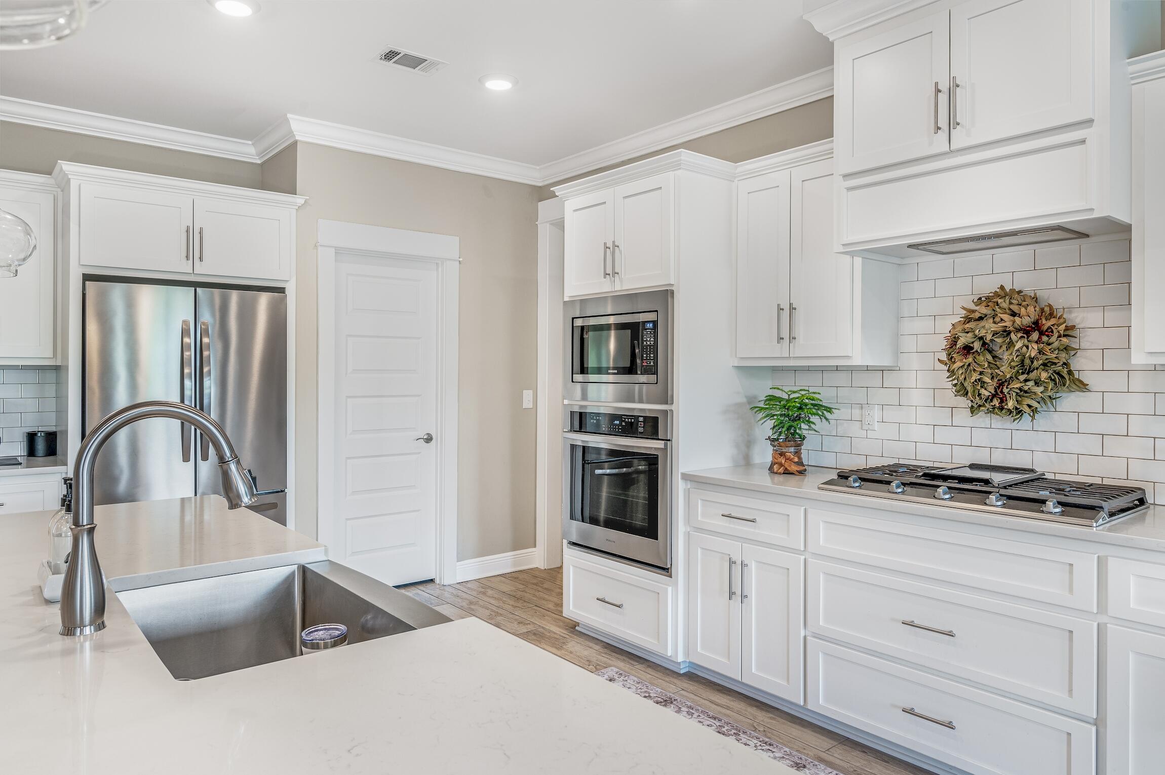 102 Mill Pond Cove Freeport, FL 32439 - Photo 15 of 46 a kitchen with stainless steel appliances granite countertop a stove a sink and a white cabinets