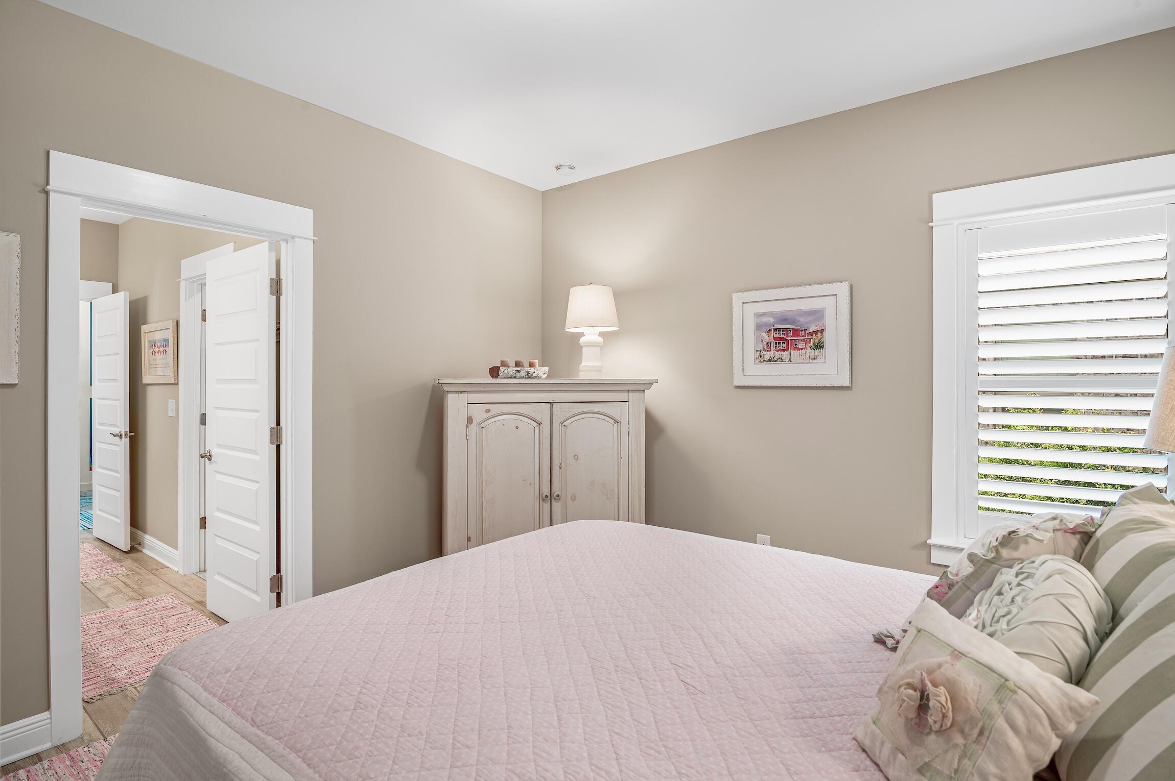 102 Mill Pond Cove Freeport, FL 32439 - Photo 24 of 46 a bedroom with a bed and a mirror