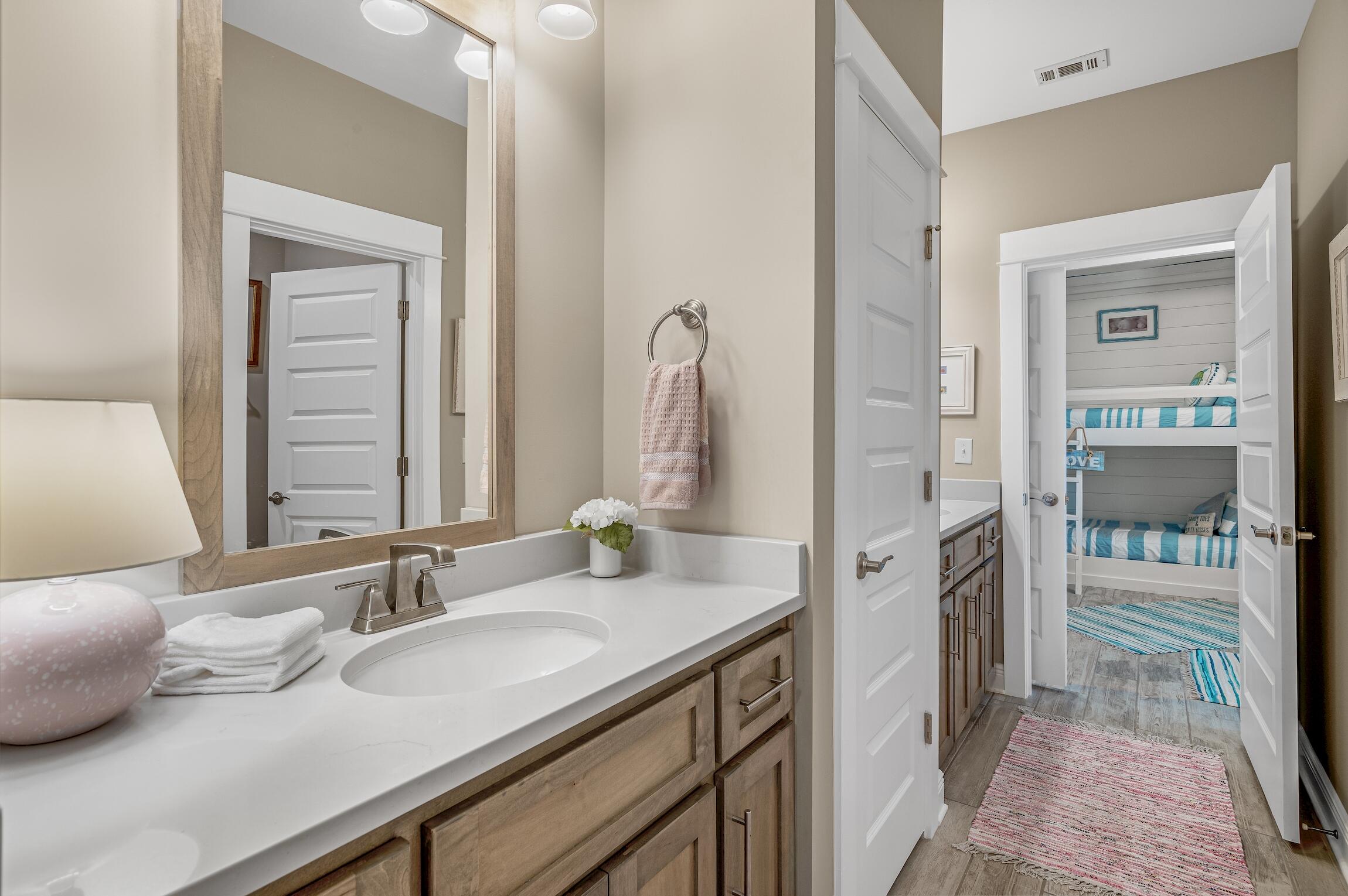 102 Mill Pond Cove Freeport, FL 32439 - Photo 25 of 46 a en suite bathroom with a granite countertop sink and a mirror