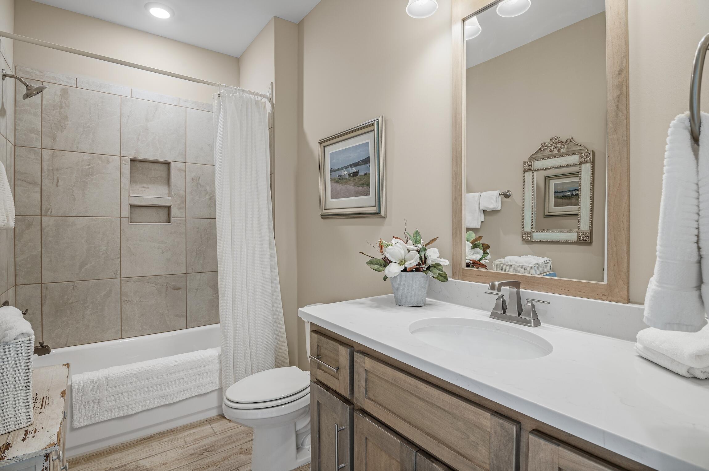 102 Mill Pond Cove Freeport, FL 32439 - Photo 28 of 46 a bathroom with a sink a toilet and shower