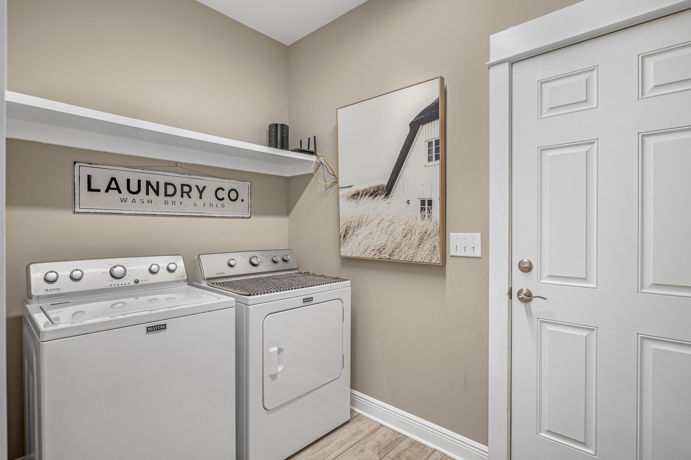 102 Mill Pond Cove Freeport, FL 32439 - Photo 29 of 46 a view of washer and dryer with kitchen in the background