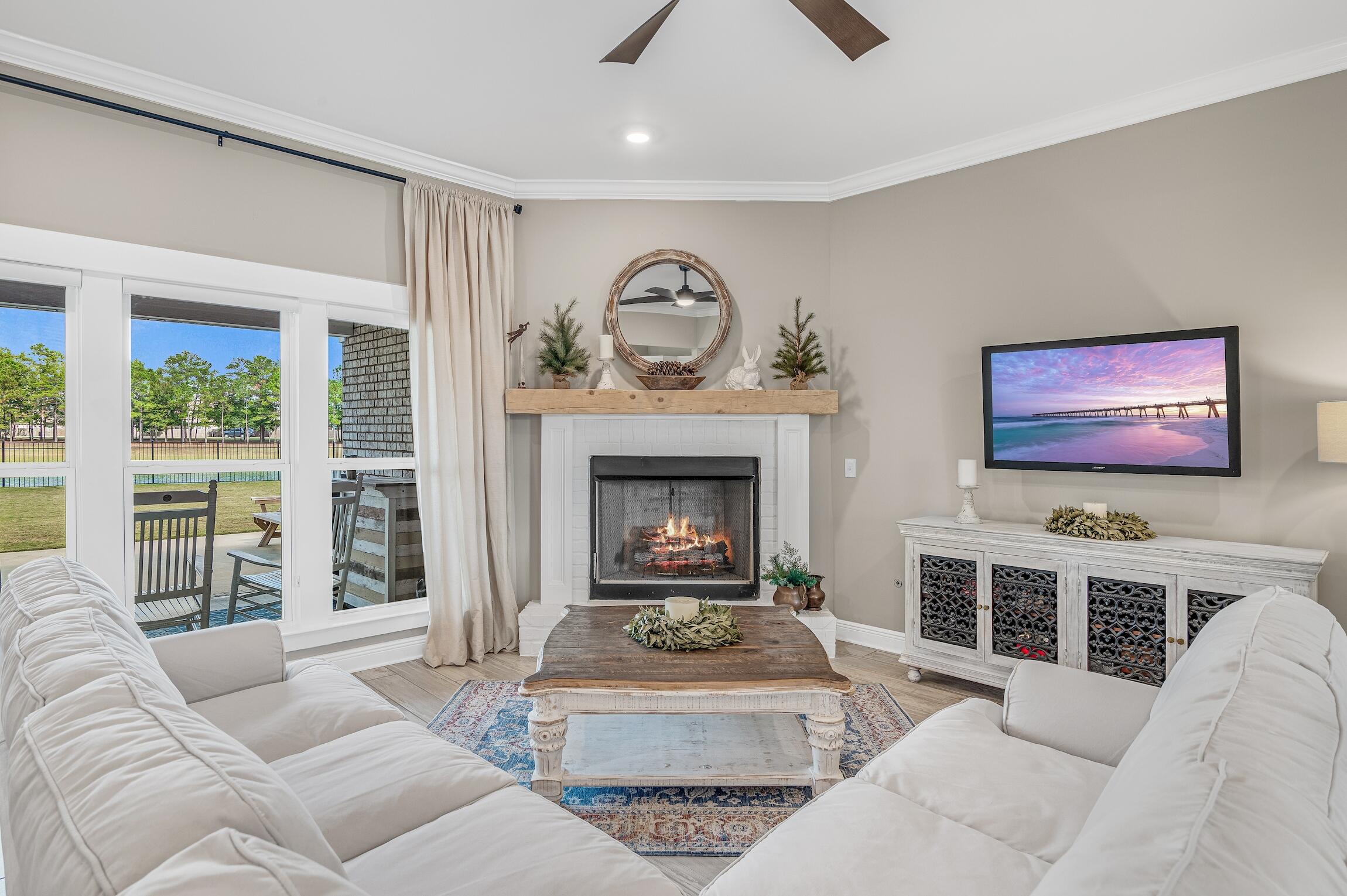 102 Mill Pond Cove Freeport, FL 32439 - Photo 9 of 46 a living room with furniture a fireplace and a flat screen tv