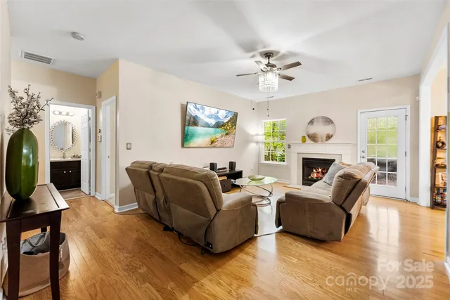 a living room with furniture a fireplace and a flat screen tv