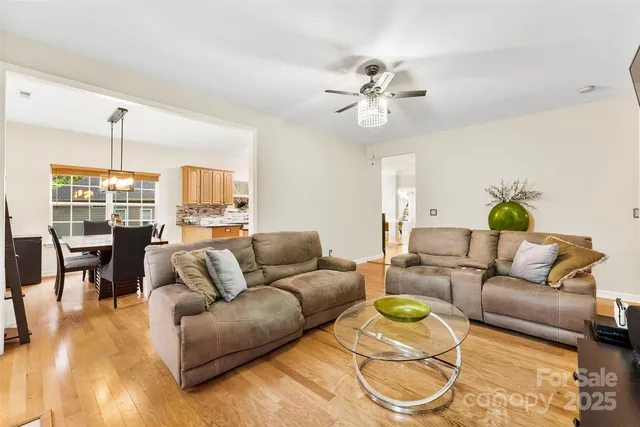 a living room with furniture and a chandelier